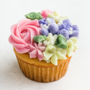 Vanilla cupcake with buttercream flowers in pink, purple, and white from Sweet Sensations bakery in Sharon, PA