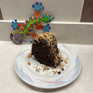 A moist slice of chocolate bundt cake topped with toasted coconut shavings from Sweet Sensations in Sharon, PA.