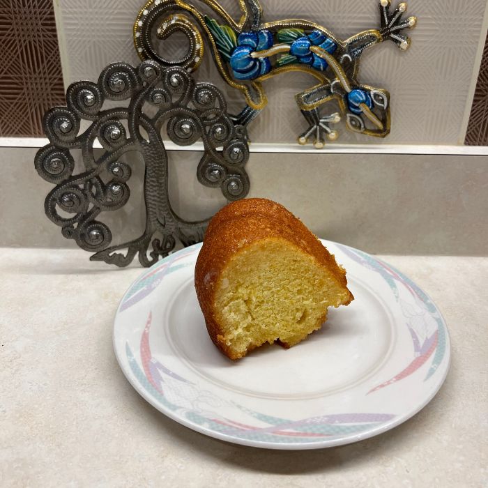 A slice of golden rum-infused bundt cake with a sweet glaze from Sweet Sensations in Sharon, PA.