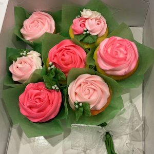 Hand-decorated pink and peach buttercream rose cupcakes by Sweet Sensations in Sharon, PA.